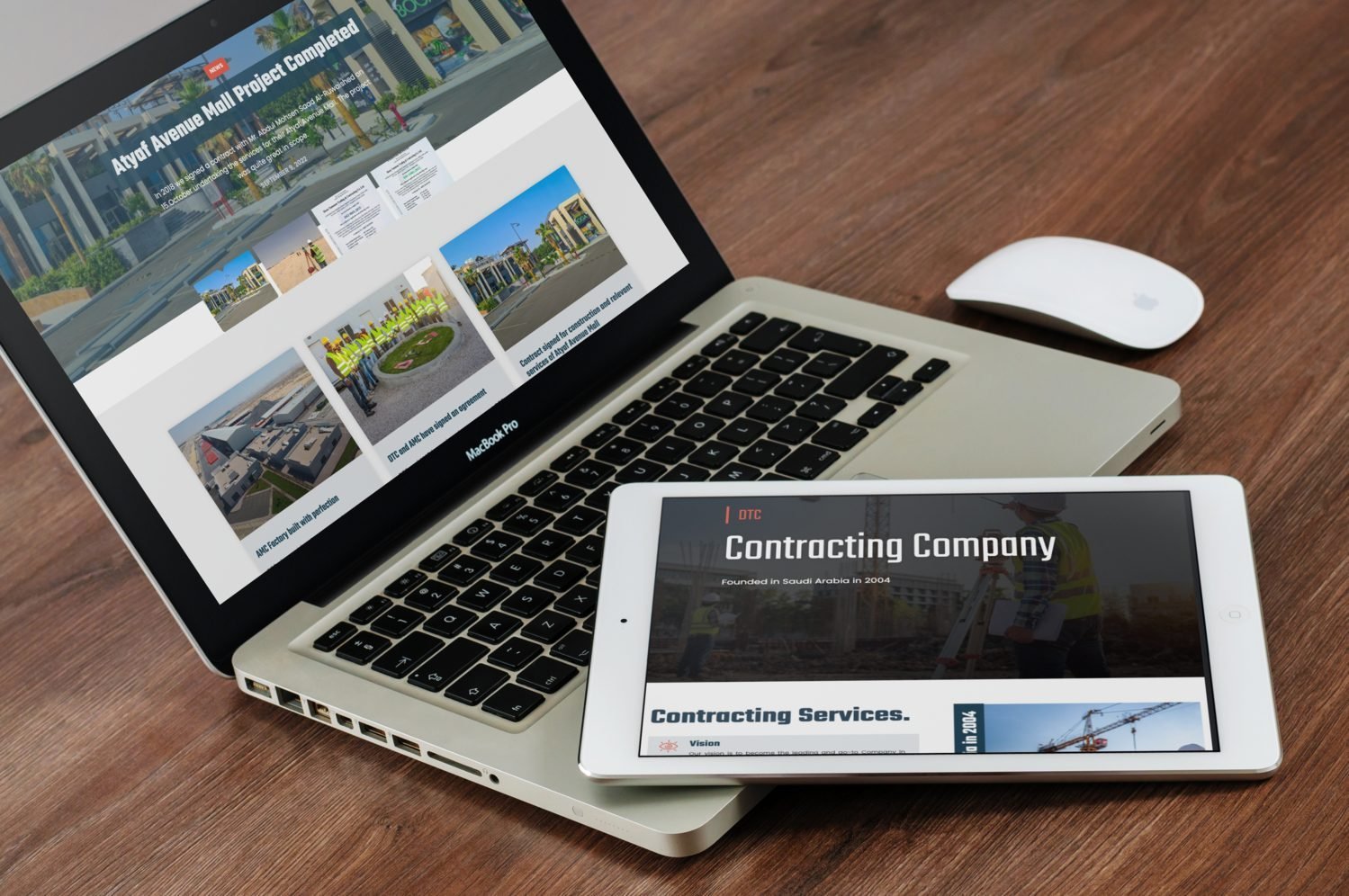 DTC corporate website on a MacBook Pro and iPad, home page hero